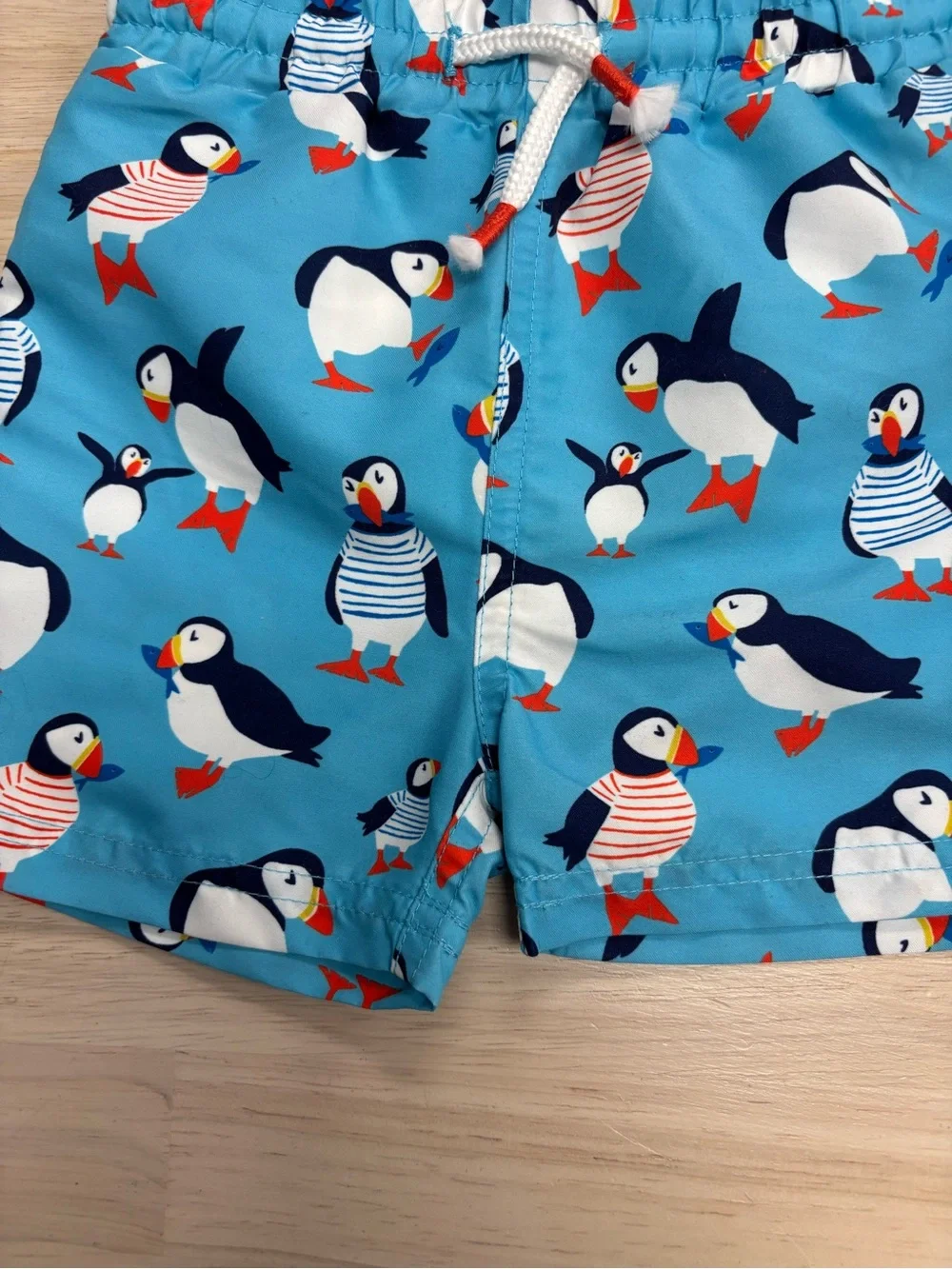 New Baby Boden puffin swim trunks